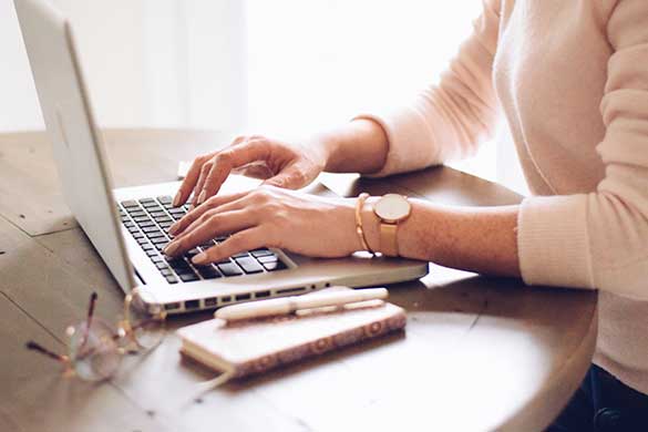 woman-is-typing-on-a-laptop-computer-sitting-at-a-desk-working-from-home_t20_no2j0n Woman typing on laptop computer