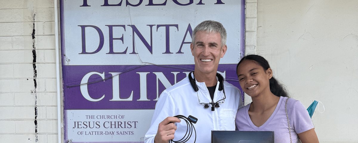 Dr. Smith holding Dream Sensor outside Pesega Dental Clinic in Samoa