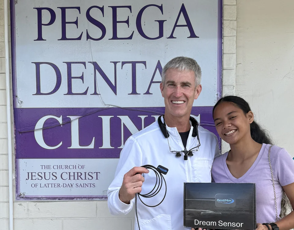 Dr. Smith holding Dream Sensor outside Pesega Dental Clinic in Samoa